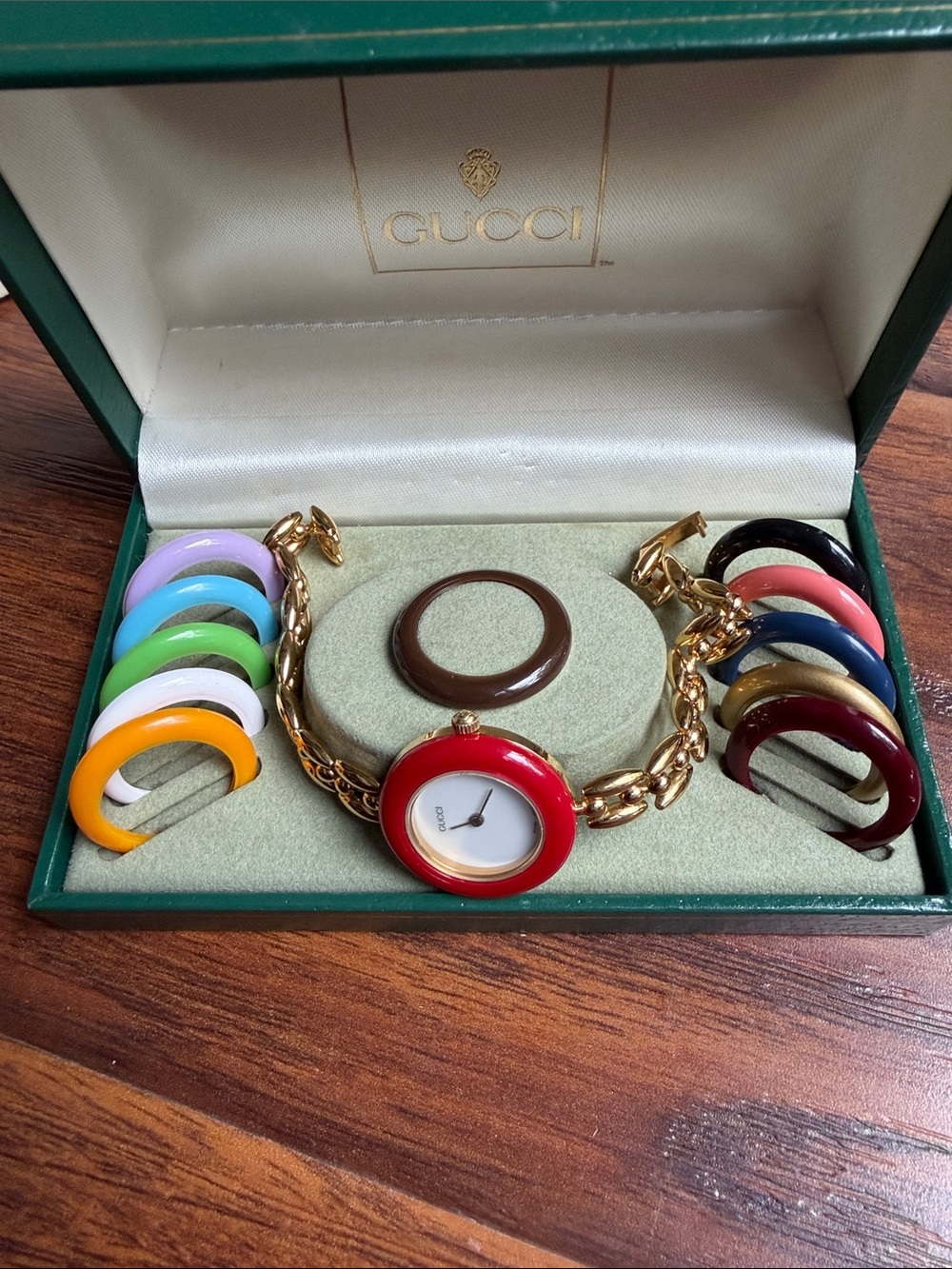 Gucci Gold-Tone Bracelet Watch with Red Bezel and Interchangeable Colored Bezels